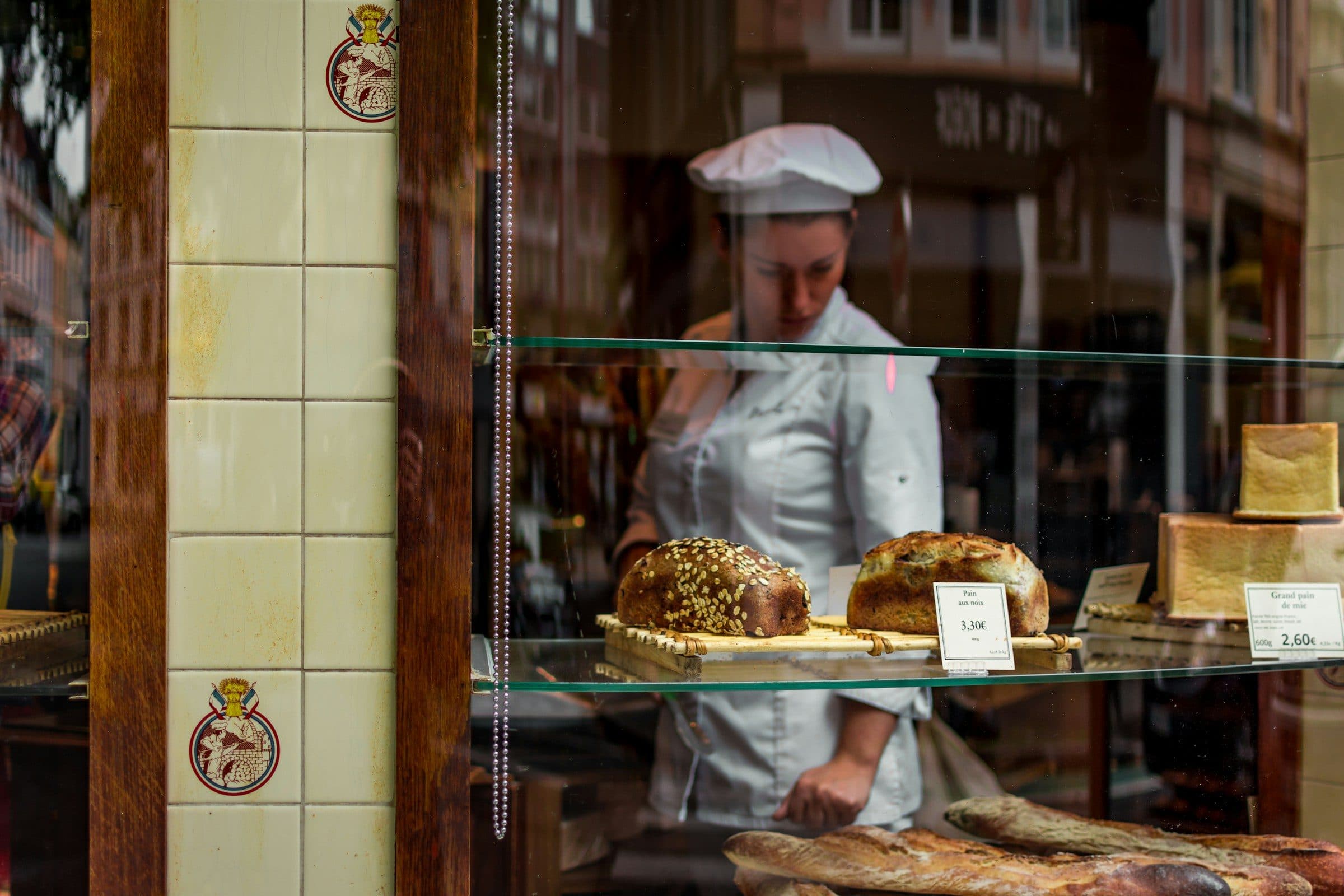 A baker seen through her shop window